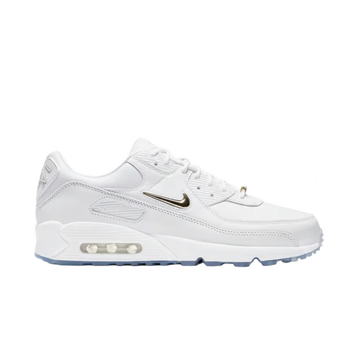 White sneaker with gold logo on a light gray background